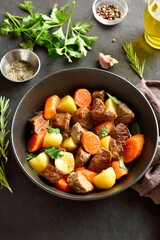 Beef stew with potatoes, carrots and greens