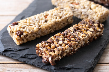 Healthy Muesli bars with nuts,seeds and black chocolate on wooden table