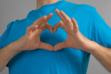 Heart-shaped palms on chest. Heart shaped hand gestures