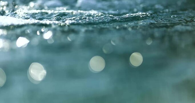 Blurred water in the pool with glare effect