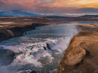 Experience the breathtaking beauty of a powerful waterfall in Iceland, captured from above. The...