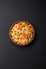 Delicious boiled rice with vegetables corn, carrots, peas with salt
