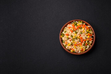 Delicious boiled rice with vegetables corn, carrots, peas with salt