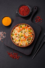 Delicious boiled rice with vegetables corn, carrots, peas with salt