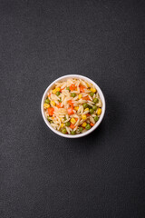Delicious boiled rice with vegetables corn, carrots, peas with salt