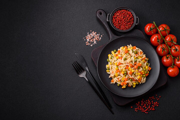 Delicious boiled rice with vegetables corn, carrots, peas with salt