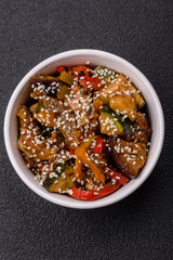 Spicy Asian dish with sliced meat fillet, hot pepper, carrots and sesame seeds