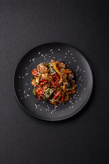 Spicy Asian dish with sliced meat fillet, hot pepper, carrots and sesame seeds