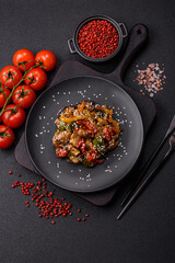Spicy Asian dish with sliced meat fillet, hot pepper, carrots and sesame seeds