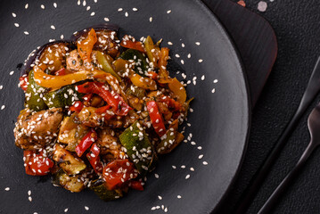 Spicy Asian dish with sliced meat fillet, hot pepper, carrots and sesame seeds