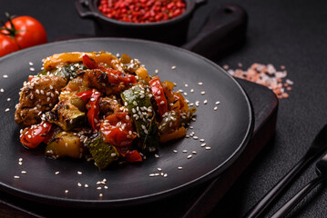 Spicy Asian dish with sliced meat fillet, hot pepper, carrots and sesame seeds