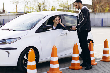 Woman passing driving test at driving school