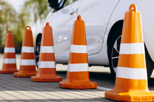 Car standing by plastic cones on parking of driving school