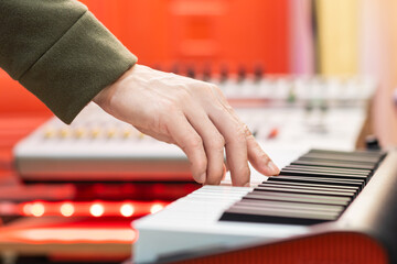 male musician hand playing on piano keys in studio. music background
