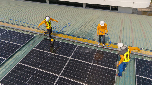 A team of engineers takes care of cleaning the solar panels outside the building. Installing solar cells on the roof Solar panels on the roof