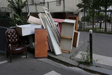 Dépôt sauvage de meubles et de planches sur un trottoir