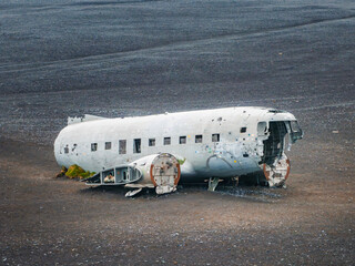 Aerial view of the Solheimasandur Plane Wreck in Iceland. Wrecked old plane Dakota on the black sand beach, south coast of Iceland