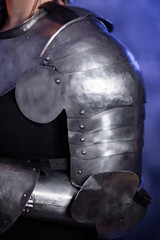 Naklejka premium Close-up of armor, knight's steel hands on an abstract background.