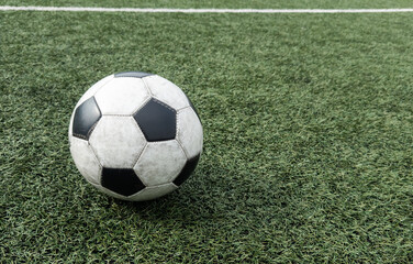 Fototapeta premium Black and white soccer and football ball in the field. Horizontal sport theme poster, greeting cards, headers, website and app