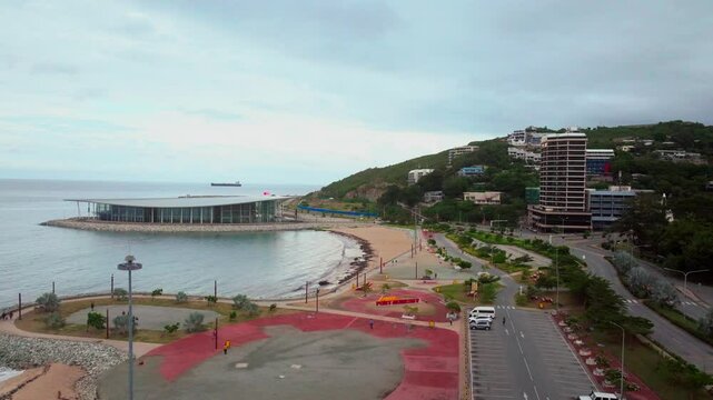 APEC Haus convention center Ela Beach Papua New Guinea aerial drone morning cloudy sunrise PNG Crown Hotel Plaza Hilton Port Moresby Harbour Marina Walter Bay Coral Sea coastline capital city upward