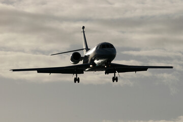 Dassault Falcon 2000 N88DD laning over Maho Beach Sint Maarten at dusk
