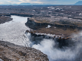 Aerial view of the Dettifoss Waterfall in Jokulsarglijufur National Park in Iceland. The Jokulsa-a-Fjollum River cascades 134m into the 500m wide canyon. Most powerful waterfall in Europe