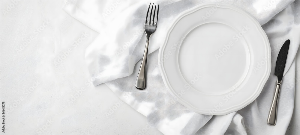 Poster 1. a simple yet elegant composition featuring a white plate, polished knife, and fork neatly arrange