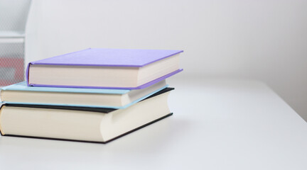 Close up mock up books stack on white table with copy space 