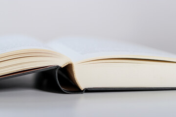 Close up of an open book on white table 