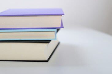 Close up mock up books stack on white table with copy space 