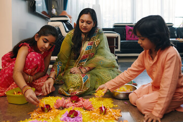 Mom making flower composition on the floor together with her children