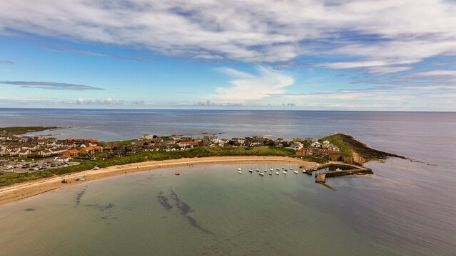 Beadnell village is set at the end of a sheltered, horseshoe-shaped beach called Beadnell Bay. This sweeping crescent of beach is fun for everyone on the Northumberland coast, with golden sand perfect
