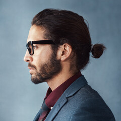 Obraz premium Face, thinking and business man with glasses for vision in profile isolated on studio background. Planning, decision and serious person remember memory, reflection or problem solving for solution