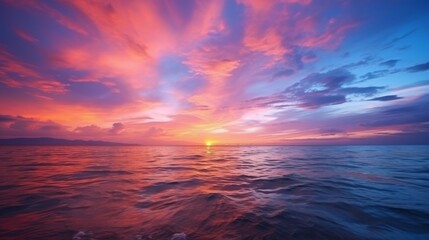 Fototapeta premium A stunning scene capturing a majestic sunset over a tranquil ocean, with a vibrant sky filled with hues of red, pink, and blue, evoking peace and wonder.