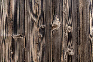 Old natural gray wooden plank wall with knots.