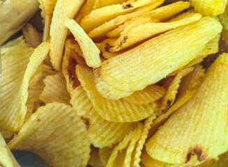 Close-Up Look at Yellow Chips: Perspective on Pattern and Texture. Inside the box, concept.