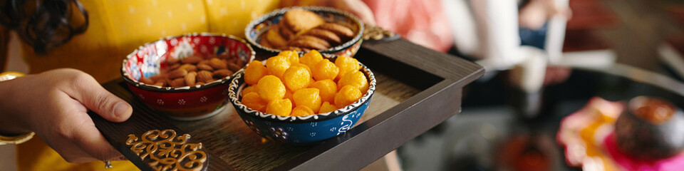 Header with woman serving sweets to tea