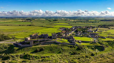 Aerial Bamburgh Castle. Bamburgh Castle, on the northeast coast of England, by the village of Bamburgh in Northumberland, is a Grade I listed building.