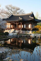 Naklejka premium A traditional Korean hanok surrounded by blooming flowers and a reflective pond, bathed in the gentle light of spring.