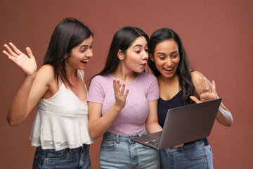 Three Strong Confident Women Are Talking With Their Friend On A Laptop