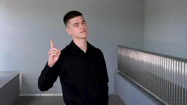 Portrait of young handsome man student or freelancer thinks questioningly and finding solution and typing on laptop computer at home Idea pointing. forward index finger concept