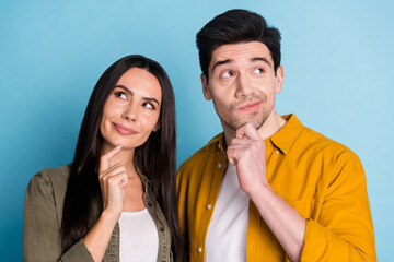 Photo of two nice young partners look interested empty space wear shirt isolated on blue color background