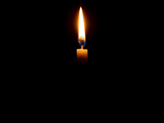 A single burning candle flame or light glowing on an orange candle on black or dark background on table in church for Christmas, funeral or memorial service with copy space