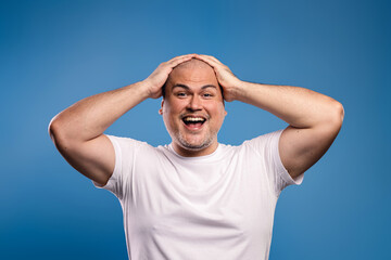 man with hands on head