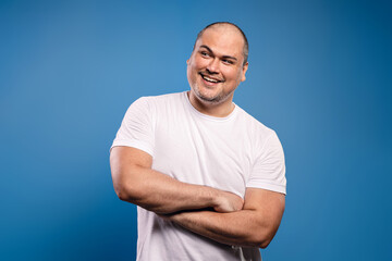 man with arms crossed looking to the side