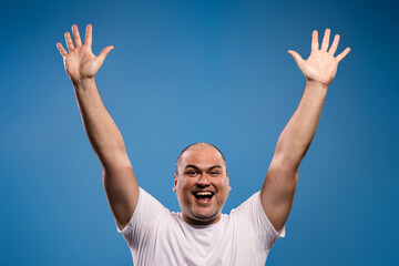 man with arms raised