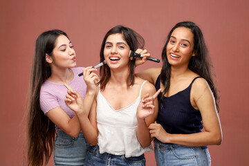 Young Sexy Women Are Smiling And Looking At The Camera While Applying Makeup