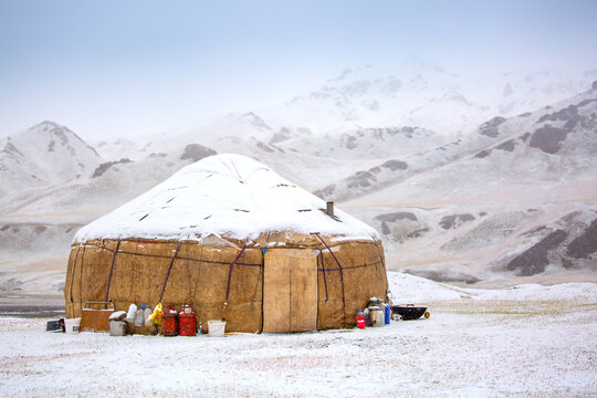 Yurts in winter. National ancient house of the peoples of Kyrgyzstan and Asian countries. national housing. Yurts against the backdrop of snow and highlands. Yurt camp for tourists.