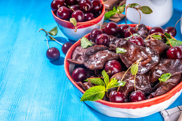 Sweet dessert chocolate dumplings vareniki with cherry berries and chocolate sauce, with sugar powder. Traditional ukrainian, polish, east european pierogi dumplings