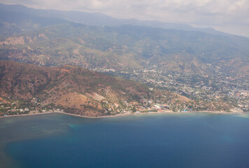 Aerial view of Dili City, the capital of Timor Leste. Urban settlements with a beach in the...